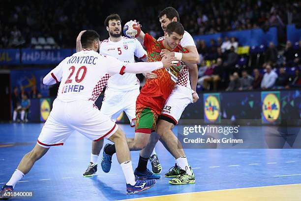 Artsem Karalek of Belarus is challenged by Tin Kontrec, Domagoj Dunjak and Luka Sebetic of Croatia during the 25th IHF Men's World Championship 2017...