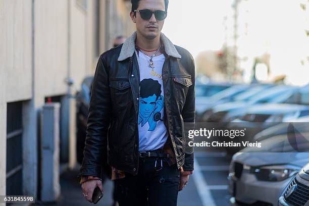 Alessandro Enriquez is wearing a leather jacket, black ripped denim jeans, sunglasses at Etro during Milan Men's Fashion Week Fall/Winter 2017/18 on...