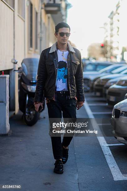 Alessandro Enriquez is wearing a leather jacket, black ripped denim jeans, sunglasses at Etro during Milan Men's Fashion Week Fall/Winter 2017/18 on...