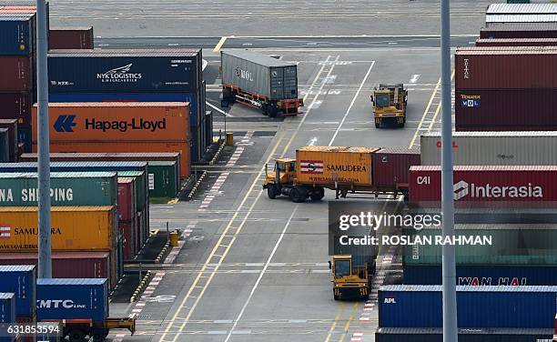 Trailer trucks ply along the passageway at Tanjong Pagar container port in Singapore on January 17, 2017. Singapore's non-oil domestic exports rose...