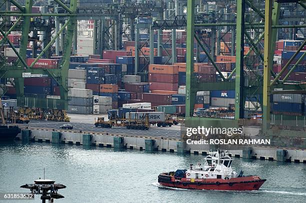 Trailer trucks ply along the passageway at Tanjong Pagar container port in Singapore on January 17, 2017. Singapore's non-oil domestic exports rose...