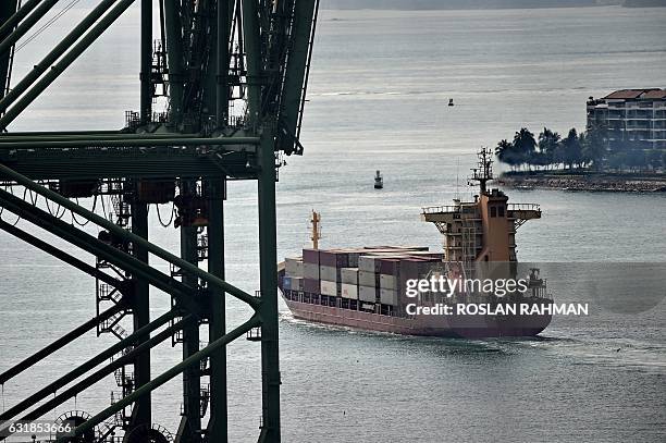 Cargo ship leaves the Tanjong Pagar container port in Singapore on January 17, 2017. Singapore's non-oil domestic exports rose 9.4 percent...