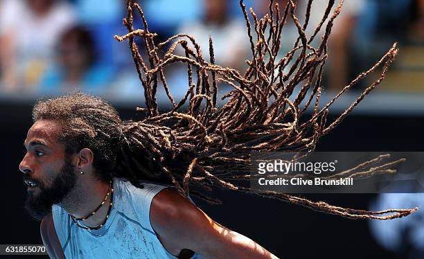 Dustin Brown of Germany serves in his first round match against Milos Raonic of Canada on day two of the 2017 Australian Open at Melbourne Park on...