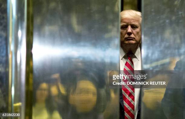 President-elect Donald Trump boards the elevator after escorting Martin Luther King III to the lobby after meetings at Trump Tower in New York City...