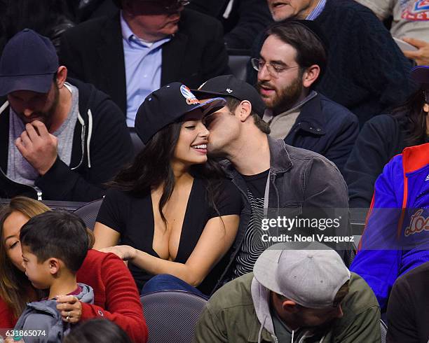 Adam DeVine kisses Chloe Bridges at a basketball game between the Oklahoma City Thunder and the Los Angeles Clippers at Staples Center on January 16,...