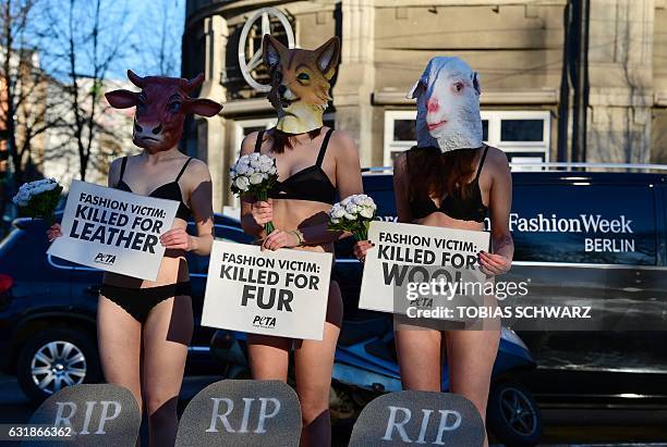 Activists of the animal right association PETA hold a protest at the Berlin Fashion Week in Berlin on January 17, 2017. / AFP / Tobias SCHWARZ