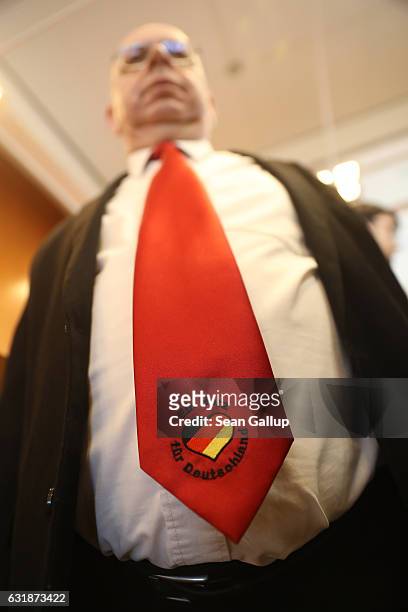 Peter Marx, head of the far-right NPD political party in the state of Saar, wears a tie that reads "A heart for Germany" with a heart and the colors...
