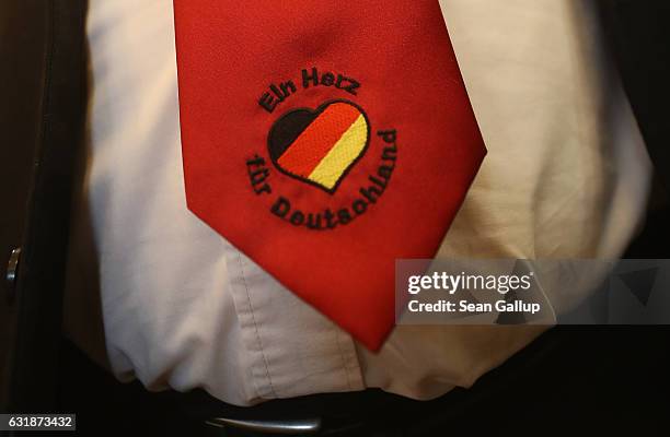 Peter Marx, head of the far-right NPD political party in the state of Saar, wears a tie that reads "A heart for Germany" with a heart and the colors...