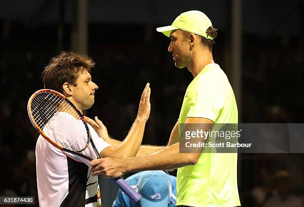 Ivo Karlovic of Croatia and Horacio Zeballos of Argentina embrace at the net after Ivo Karlovic won his first round match against Horacio Zeballos of...