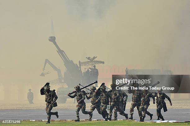 Indian Army soldiers take part in a mock drill during the Army Day parade in New Delhi.