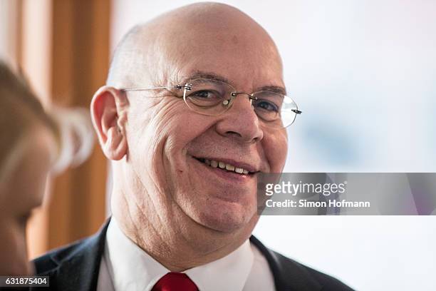 Peter Marx, a leading member of the NPD, smiles after the conclusion of the session of the Federal Constitutional Court in which the court announced...