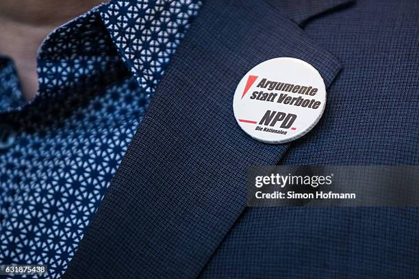 General view of a button that reads 'Arguments instead of bans. NPD.' after the conclusion of the session of the Federal Constitutional Court in...