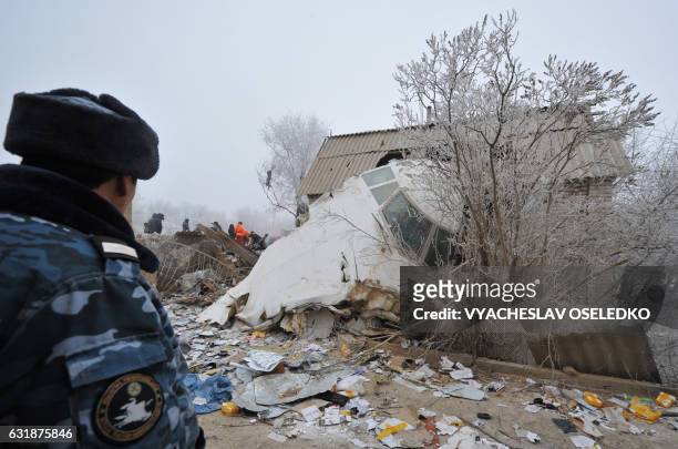 Rescue personnel and investigators work at the crash site of a Turkish cargo plane in the village of Dacha-Suu outside Bishkek on January 17, 2017. A...