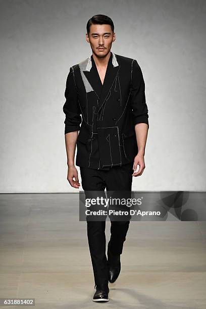 Actor Hu Bing walks the runway at the Consistence show during Milan Men's Fashion Week Fall/Winter 2017/18 on January 17, 2017 in Milan, Italy.