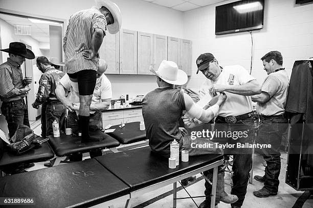 Buck Off at the Garden: Portrait of riders being prepped in dressing room during photo shoot before event at Madison Square Garden. Behind the...