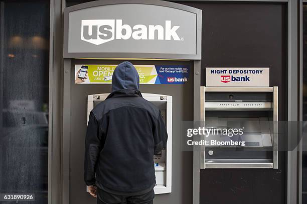 Customer uses a automatic teller machine outside a US Bancorp branch in San Francisco, California, U.S., on Friday, Jan. 13, 2017. US Bancorp is...