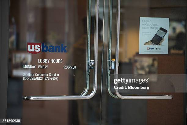 Signage is displayed on an entrance of a US Bancorp branch in San Francisco, California, U.S., on Friday, Jan. 13, 2017. US Bancorp is scheduled to...