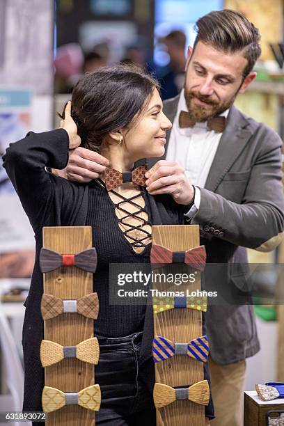 Kyriaskos and Zoe test a wooden bow tie at Ethical Fashion Show Berlin during Mercedes-Benz Fashion Week Berlin A/W 2017/18 on January 17, 2017 in...