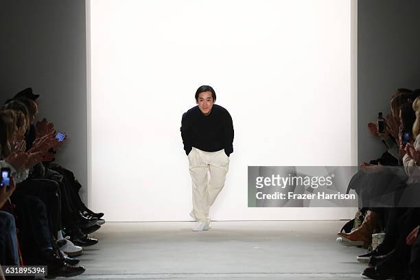 Designer Hien Le acknowledges the audience following his show during the Mercedes-Benz Fashion Week Berlin A/W 2017 at Kaufhaus Jandorf on January...