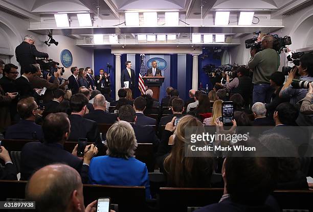 President Barack Obama surprises White House Press Secretary Josh Earnest during his last briefing for the administration at the White House, on...