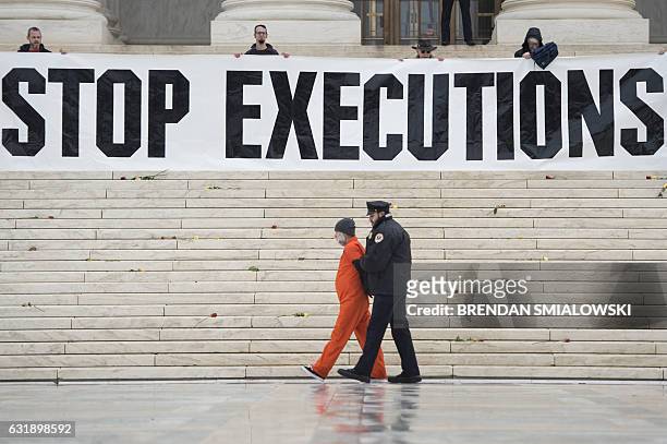 Randy Gardner is removed by police while wearing his executed brother's prison jumpsuit during an anti death penalty protest at the US Supreme Court...