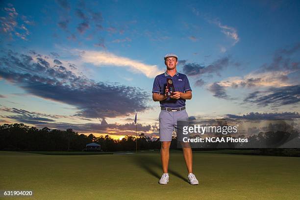 Bryson Dechambeau of Southern Methodist University holds his trophy on the 18th green of the Concession Golf Club in Bradenton, Florida after winning...