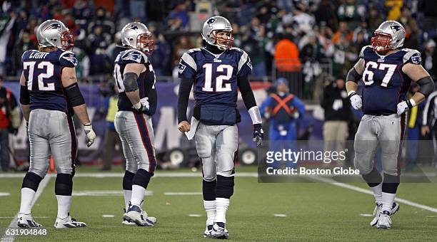 From left: Patriots Matt Light, Logan Mankins, Tom Brady and Dan Koppen are shown late in the game as the season is slipping away for New England....