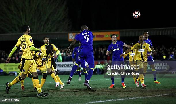 Tom Elliott of AFC Wimbledon scores his sides first goal with a header during the Emirates FA Cup third round replay between AFC Wimbledon and Sutton...