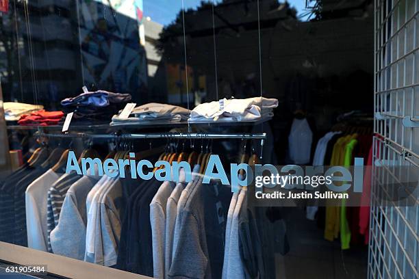 Clothing hangs on a rack at an American Apparel retail store on January 17, 2017 in Los Angeles, California. American Apparel has begun laying off...