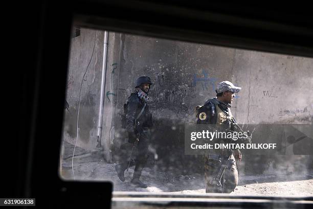 Picture taken through a windshield of a Humvee shows members of the Iraqi special forces Counter Terrorism Service patroling in Mosul's al-Jazair...