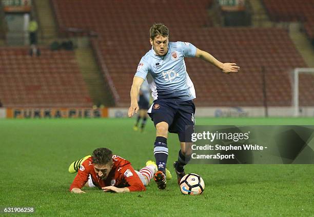 Blackpool's Jim McAlister and Barnsley's Angus MacDonald during the Emirates FA Cup Third Round Replay match between Barnsley and Blackpool at...