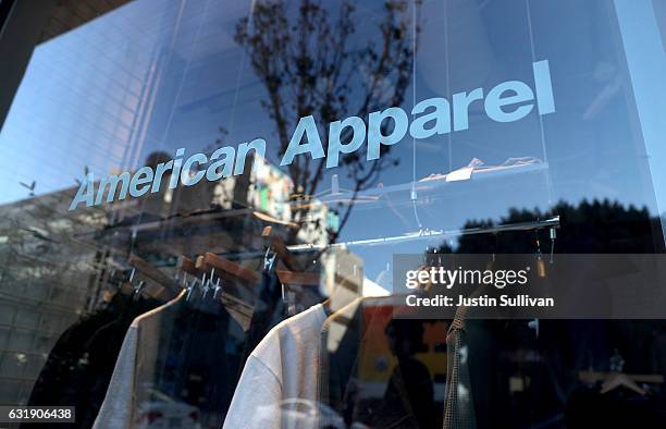 The American Apparel is displayed on a window at a retail store on January 17, 2017 in Los Angeles, California. American Apparel has begun laying off...