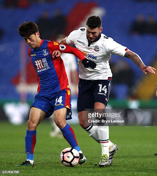 Chung-yong Lee of Crystal Palace and Gary Madine of Bolton battle for possession during the Emirates FA Cup third round replay between Crystal Palace...