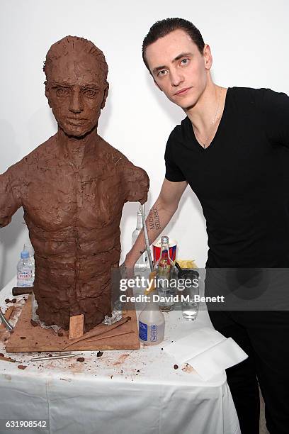Sergei Polunin poses next to the sculpture while Artist Frances Segelman sculpts dancer Sergei Polunin at The Hospital Club Gallery on January 17,...