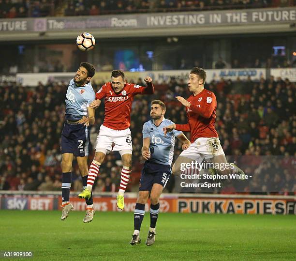 Blackpool's Kelvin Mellor battles with Barnsley's Josh Scowen and Angus MacDonald during the Emirates FA Cup Third Round Replay match between...