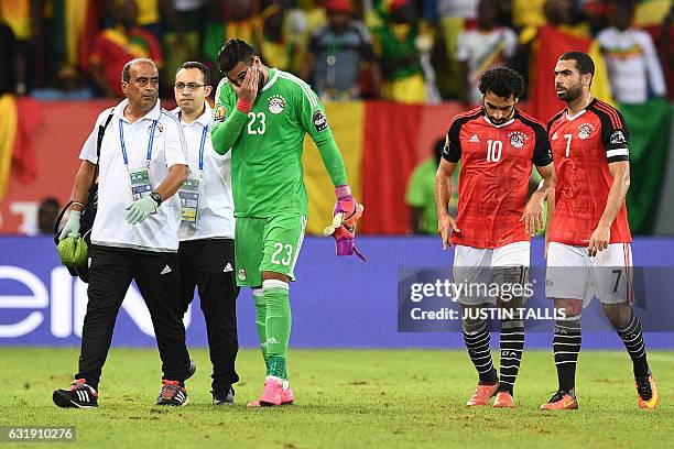 Egypt's goalkeeper Ahmed El-Shenawy reacts as he walks off the pitch due to an injury during the 2017 Africa Cup of Nations group D football match...