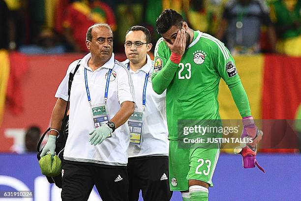 Egypt's goalkeeper Ahmed El-Shenawy reacts as he walks off the pitch due to an injury during the 2017 Africa Cup of Nations group D football match...