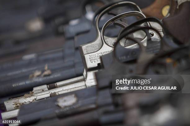 An assortment of handguns from the more than five thousand weapons used in felonies and seized by the Mexican Army from drug traffickers in the...