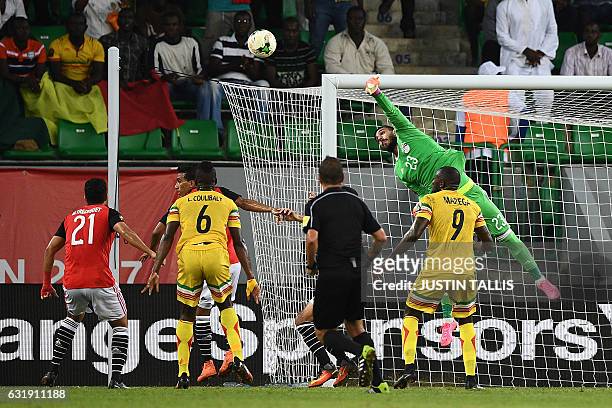Egypt's goalkeeper Ahmed El-Shenawy punches the ball away from the goal during the 2017 Africa Cup of Nations group D football match between Mali and...