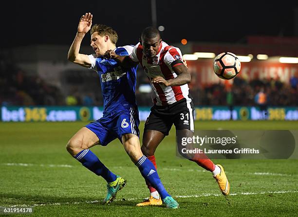 Christophe Berra of Ipswich Town and Theo Robinson of Lincoln City battle for possession during the Emirates FA Cup third round replay between...