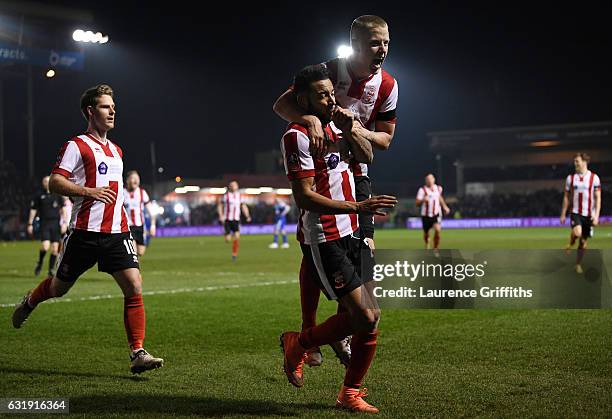 Nathan Arnold of Lincoln City celebrates scoring his sides first goal with his Lincoln team mates during the Emirates FA Cup third round replay...