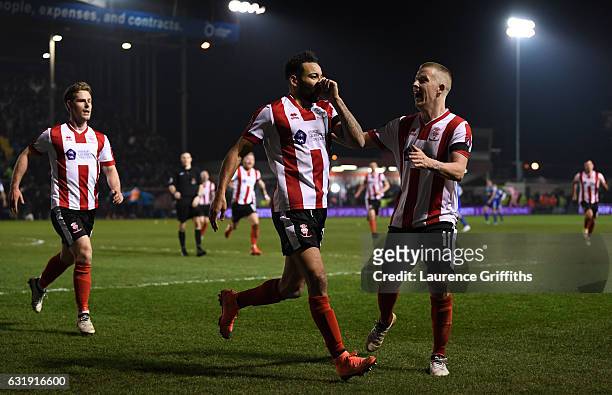 Nathan Arnold of Lincoln City celebrates scoring his sides first goal with his Lincoln team mates during the Emirates FA Cup third round replay...