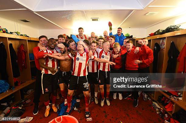 The Lincoln team and staff celebrate their victory in the changing room after the Emirates FA Cup third round replay between Lincoln City and Ipswich...