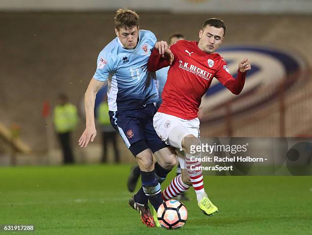 Blackpool's Jim McAlister and Barnsley's Josh Scowen during the Emirates FA Cup Third Round Replay match between Barnsley and Blackpool at Oakwell...