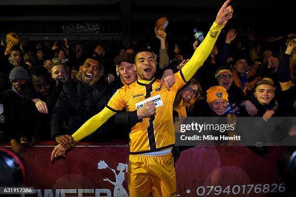 Maxime Biamou of Sutton United celebrates with the Sutton United fans during the Emirates FA Cup third round replay between AFC Wimbledon and Sutton...