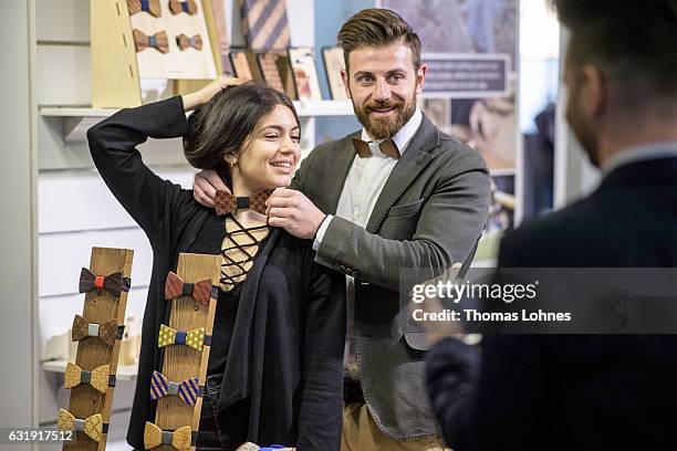 Kyriaskos and Zoe test a wooden bow tie at Ethical Fashion Show Berlin during Mercedes-Benz Fashion Week Berlin A/W 2017/18 at on January 17, 2017 in...