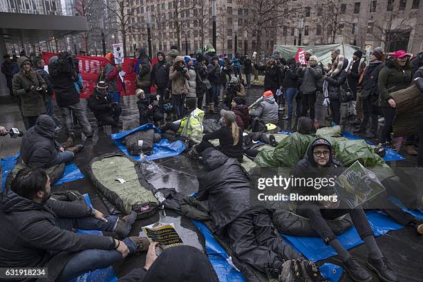 Demonstrators lay out sleeping bags during a protest outside Goldman Sachs Group Inc. Headquarters in New York, U.S., on Tuesday, Jan. 17, 2017. "We...