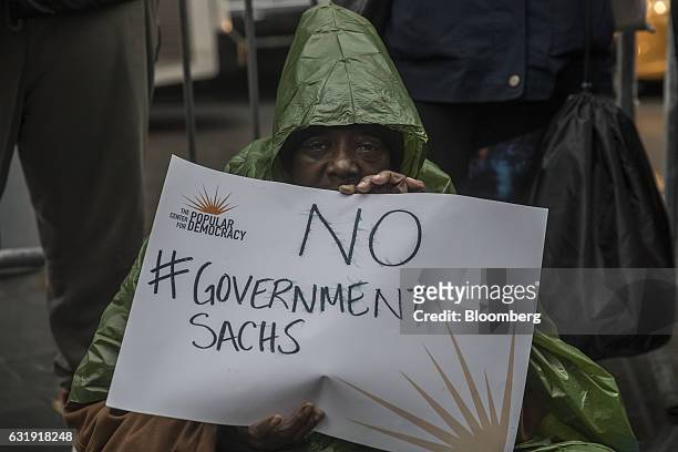Demonstrator holds a sign reading "No #Government Sachs" during a protest outside Goldman Sachs Group Inc. Headquarters in New York, U.S., on...