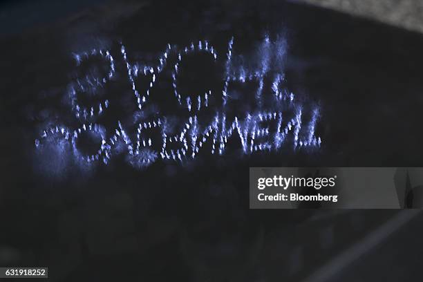 Chalk smeared on the wet pavement reads, "Government Sachs" during a protest outside Goldman Sachs Group Inc. Headquarters in New York, U.S., on...