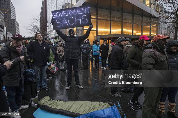 Demonstrator holds up a sign reading "Government Sachs" during a protest outside Goldman Sachs Group Inc. Headquarters in New York, U.S., on Tuesday,...